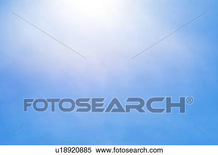 Stock Photography - Sun behind small cloud on blue sky. Fotosearch