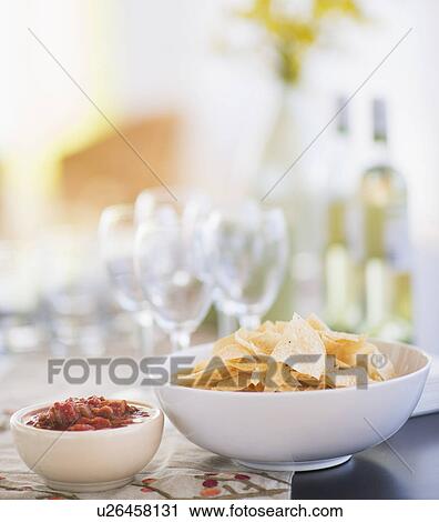 Stock Image - Table with snacks and wine glasses. Fotosearch