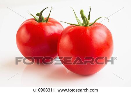 Stock Image - Tomatoes on white background, studio shot. Fotosearch