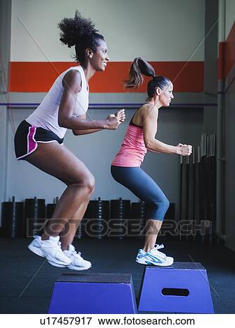 Two women in step aerobics class View Large Photo Image Stock Photo - Two women in step aerobics class. Fotosearch