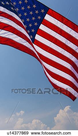 US flag against blue sky View Large Photo Image Stock Photo - US flag against blue sky. Fotosearch