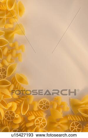 Stock Image - Variety of yellow pasta with blank white space in upper right corner. Fotosearch