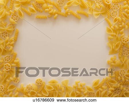 Stock Photo - Variety of yellow pasta with blank white space in middle. Fotosearch
