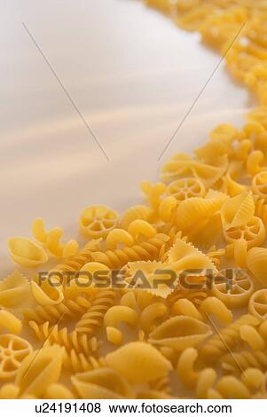 Stock Photo - Variety of yellow pasta with blank white space in upper left corner. Fotosearch