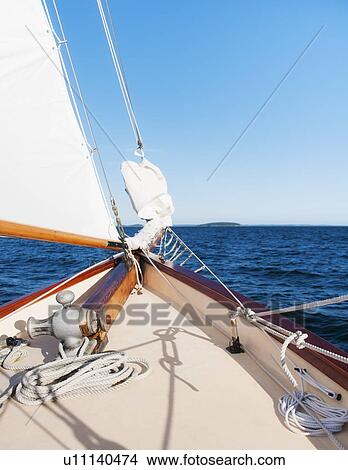 View of sea with yacht bow and sail in foreground View Large Photo Image Picture - View of sea with yacht bow and sail in foreground. Fotosearch