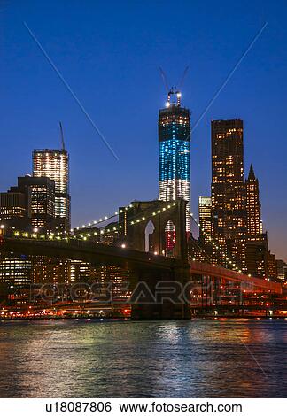 Stock Photograph - View over Hudson River towards Manhattan with Freedom Tower One and Brooklyn Bridge. Fotosearch