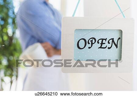 Waiter standing next to open sign View Large Photo Image Stock Image - Waiter standing next to open sign. Fotosearch
