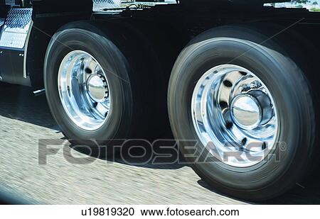 Stock Image - Wheels of truck in motion. Fotosearch