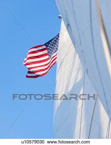 White sails and American flag against blue sky View Large Photo Image Stock Image - White sails and American flag against blue sky. Fotosearch
