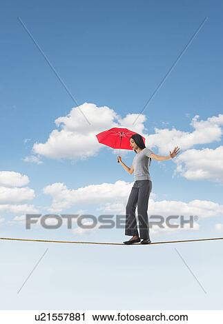Woman balancing on tightrope View Large Photo Image Stock Image - Woman balancing on tightrope. Fotosearch