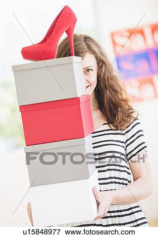Stock Photo - Woman carrying shoes boxes. Fotosearch