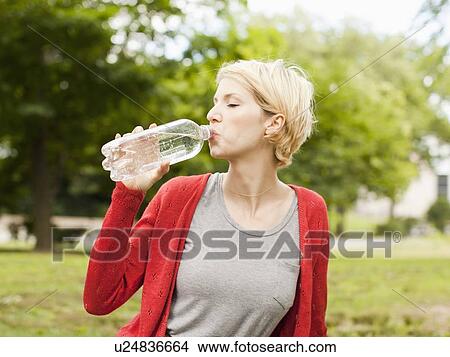 Picture - Woman drinking water from bottle. Fotosearch