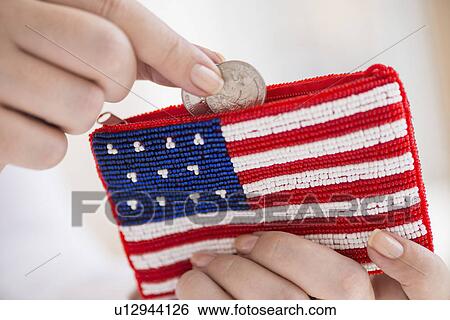 Woman holding coins and purse with american flag on it View Large Photo Image Stock Photograph - Woman holding coins and purse with american flag on it. Fotosearch