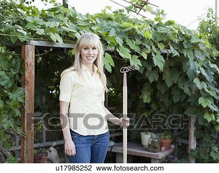 Stock Image - Woman in garden. Fotosearch