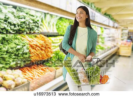 Woman in grocery store View Large Photo Image Stock Image - Woman in grocery store. Fotosearch