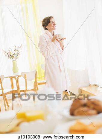 Woman in white robe drinking tea View Large Photo Image Stock Photo - Woman in white robe drinking tea. Fotosearch