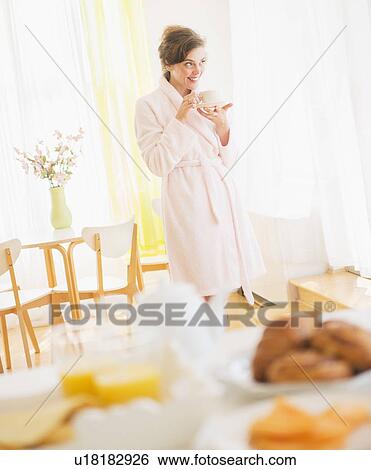 Woman in white robe drinking tea View Large Photo Image Stock Photograph - Woman in white robe drinking tea. Fotosearch