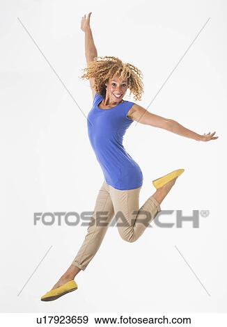 Woman jumping, studio shot View Large Photo Image Stock Photo - Woman jumping, studio shot. Fotosearch