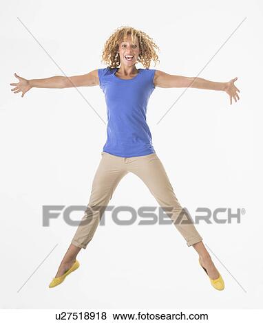 Stock Photo - Woman jumping, studio shot. Fotosearch