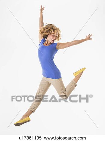 Stock Photography - Woman jumping, studio shot. Fotosearch