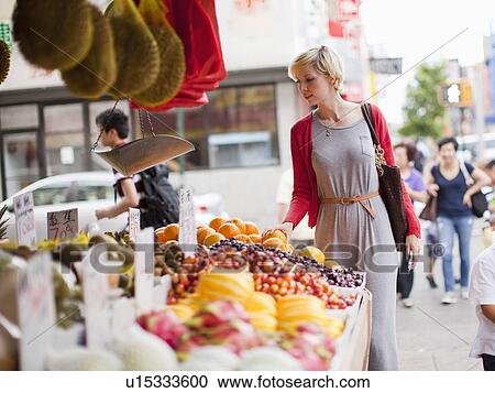 Woman looking at fresh friuts at street market View Large Photo Image Stock Image - Woman looking at fresh friuts at street market. Fotosearch