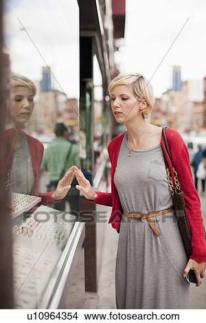 Woman looking at shop display View Large Photo Image Picture - Woman looking at shop display. Fotosearch