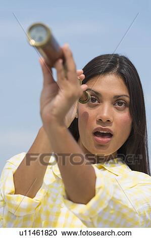 Woman looking through telescope View Large Photo Image Stock Image - Woman looking through telescope. Fotosearch