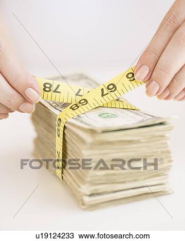 Woman measuring bunch of banknotes View Large Photo Image Stock Image - Woman measuring bunch of banknotes. Fotosearch
