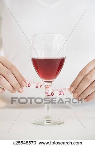 Woman measuring glass with rose wine View Large Photo Image Stock Image - Woman measuring glass with rose wine. Fotosearch
