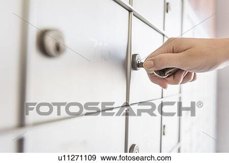 Woman opening safety deposit box View Large Photo Image Stock Photo - Woman opening safety deposit box. Fotosearch