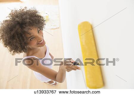 Woman painting house View Large Photo Image Stock Photo - Woman painting house. Fotosearch