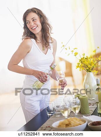 Woman pouring wine to glass View Large Photo Image Stock Image - Woman pouring wine to glass. Fotosearch