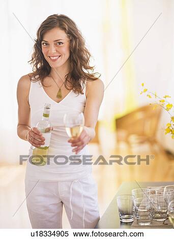 Woman pouring wine to glass View Large Photo Image Stock Photography - Woman pouring wine to glass. Fotosearch
