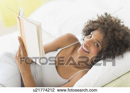 Woman reading in bed View Large Photo Image Stock Image - Woman reading in bed. Fotosearch
