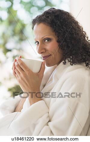 Woman relaxing with cup of coffee View Large Photo Image Stock Image - Woman relaxing with cup of coffee. Fotosearch