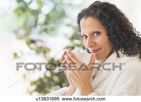 Woman relaxing with cup of coffee View Large Photo Image Stock Photo - Woman relaxing with cup of coffee. Fotosearch