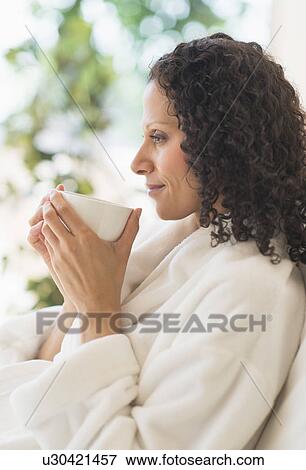 Woman relaxing with cup of coffee View Large Photo Image Stock Photo - Woman relaxing with cup of coffee. Fotosearch