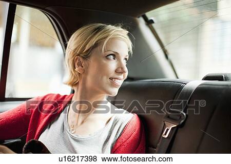 Woman sitting in back seat of car View Large Photo Image Stock Photo - Woman sitting in back seat of car. Fotosearch