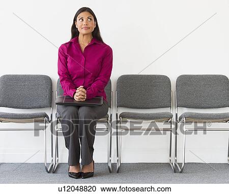 Woman sitting in waiting room View Large Photo Image Stock Image - Woman sitting in waiting room. Fotosearch