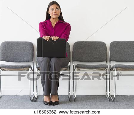 Woman sitting in waiting room View Large Photo Image Stock Image - Woman sitting in waiting room. Fotosearch