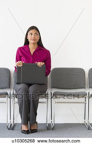 Woman sitting in waiting room View Large Photo Image Stock Photo - Woman sitting in waiting room. Fotosearch