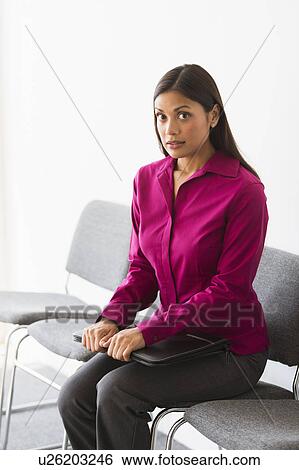 Woman sitting in waiting room View Large Photo Image Stock Photograph - Woman sitting in waiting room. Fotosearch