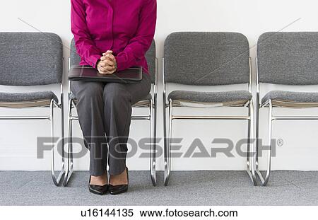 Woman sitting in waiting room View Large Photo Image Stock Photography - Woman sitting in waiting room. Fotosearch