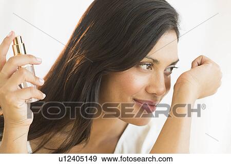 Woman smelling perfume on wrist View Large Photo Image Stock Photo - Woman smelling perfume on wrist. Fotosearch