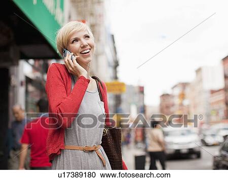 Woman smiling and talking on phone View Large Photo Image Stock Image - Woman smiling and talking on phone. Fotosearch