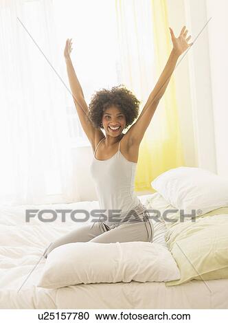 Woman stretching on bed View Large Photo Image Stock Image - Woman stretching on bed. Fotosearch