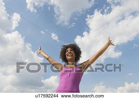 Woman stretching under blue sky View Large Photo Image Picture - Woman stretching under blue sky. Fotosearch