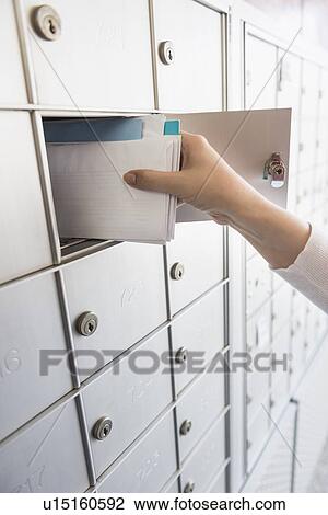 Woman taking letters from safety deposit box View Large Photo Image Stock Image - Woman taking letters from safety deposit box. Fotosearch
