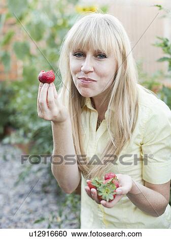 Woman tasting strawberries View Large Photo Image Stock Image - Woman tasting strawberries. Fotosearch