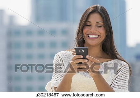 Stock Photo - Woman text messaging. Fotosearch